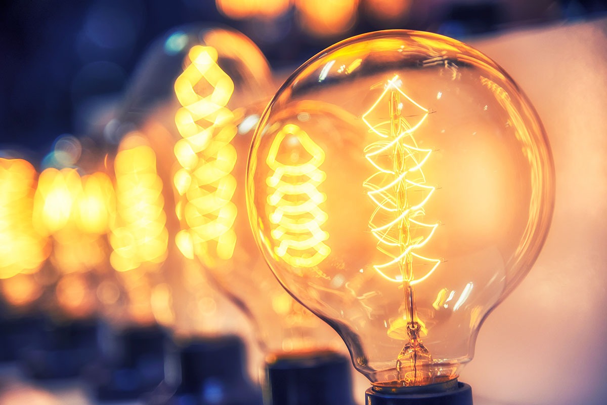 Multiple vintage lightbulbs in the foreground and background