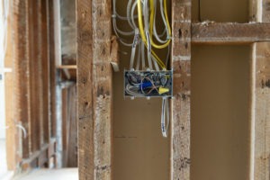 rough home construction, showing inside walls and electrical work before drywall