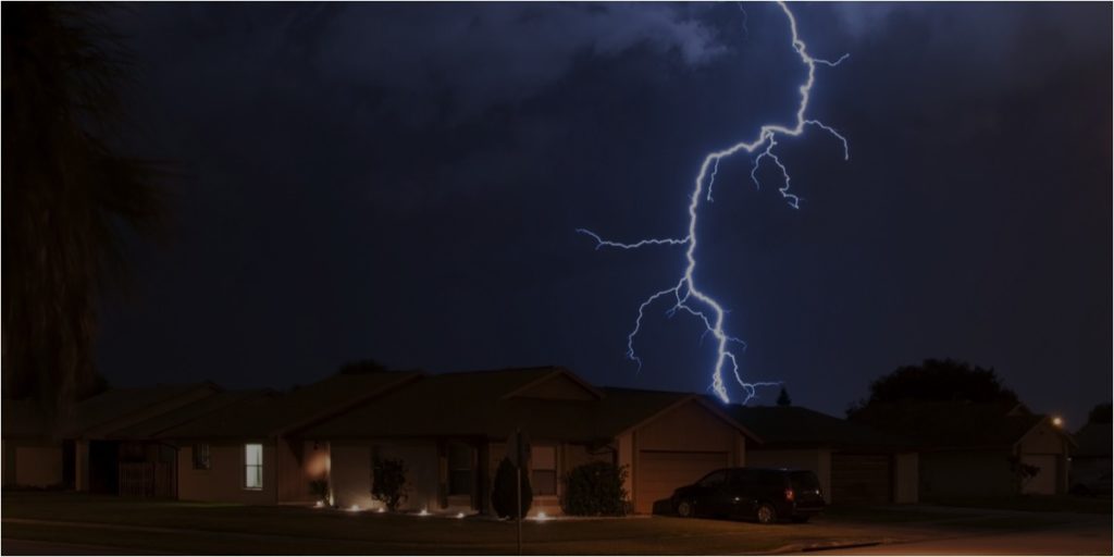 lightning at night behind house