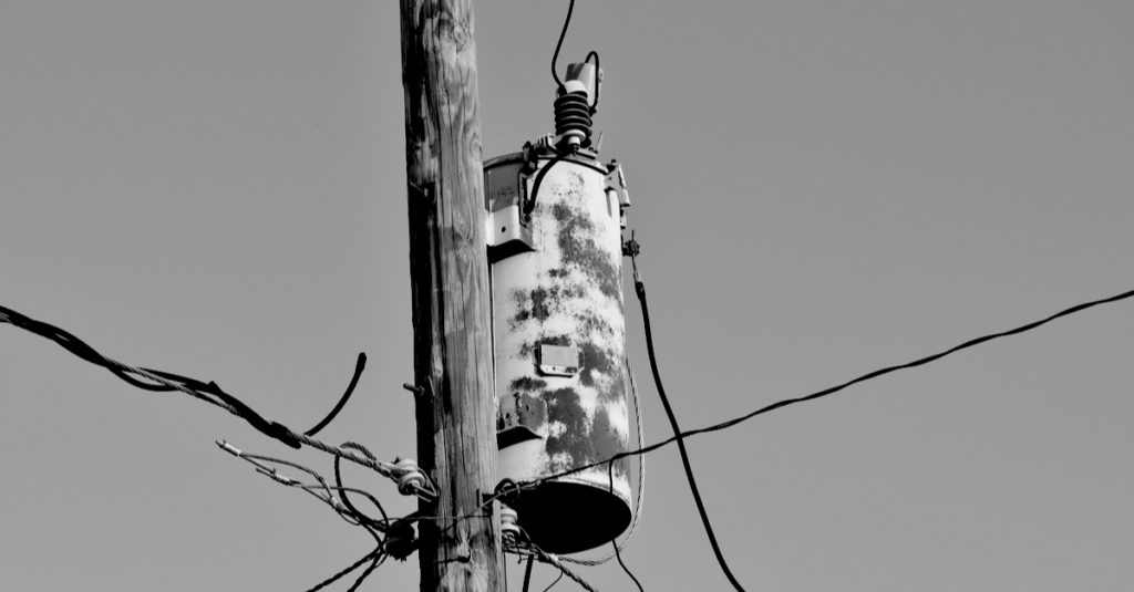 old electrical transformer on pole