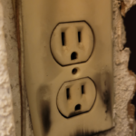 closeup of outlet with burn marks