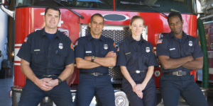 Fire department crew posing in front of a fire truck