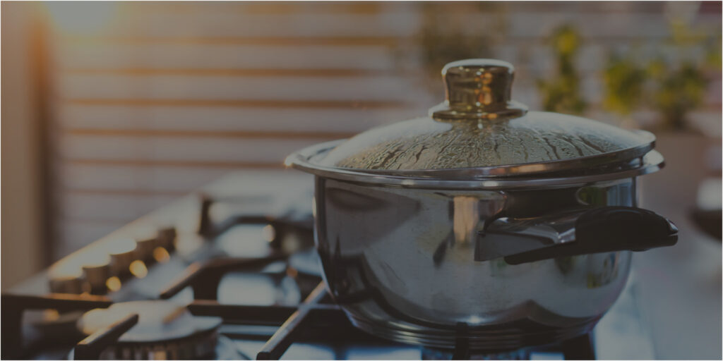 Pan with lid cooking on stovetop