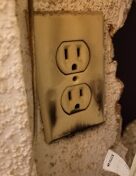 wall electrical outlet with signs of charring