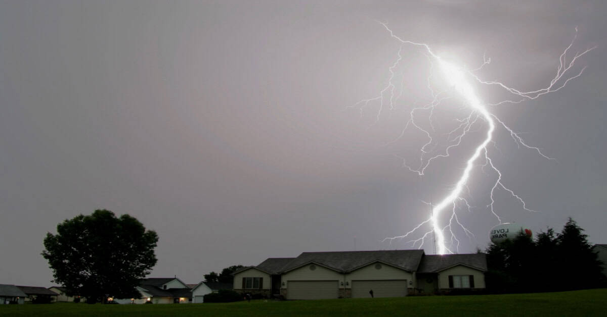 Lightning strike nearby and behind a home.