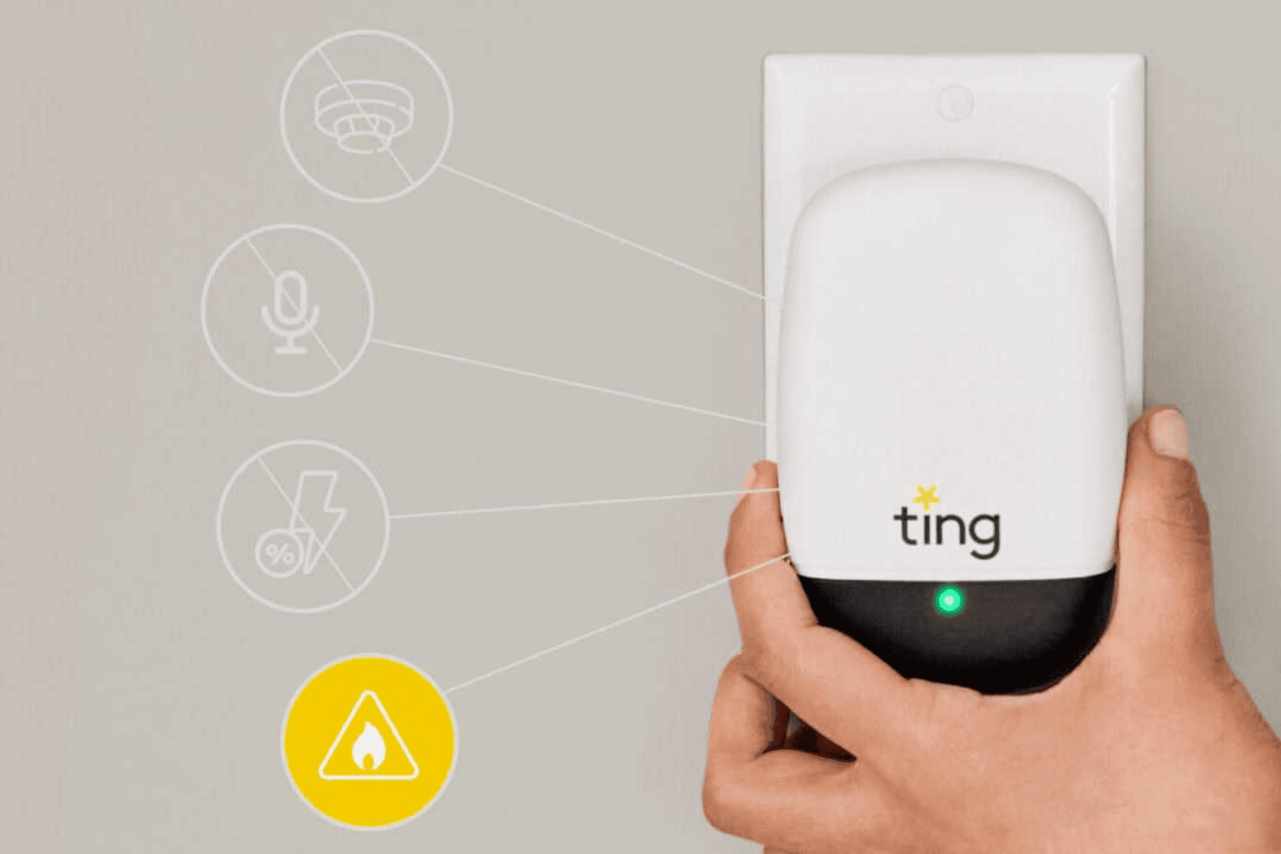 Hand plugging a Ting sensor into a wall outlet.